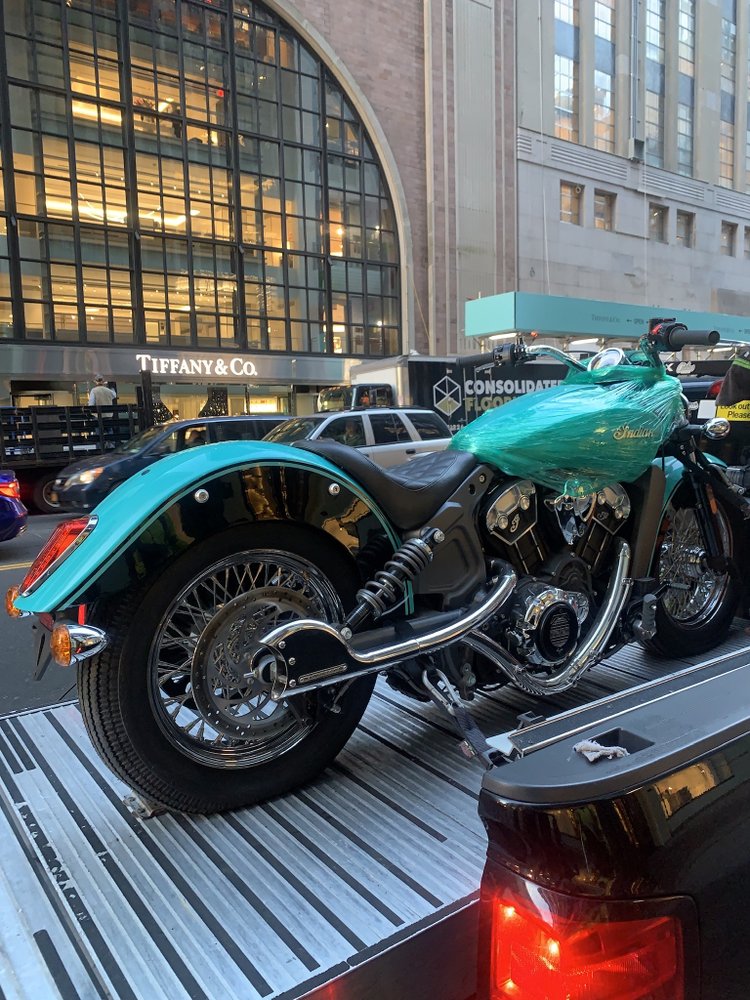 Classic motorcycle loaded on a flatbed tow truck