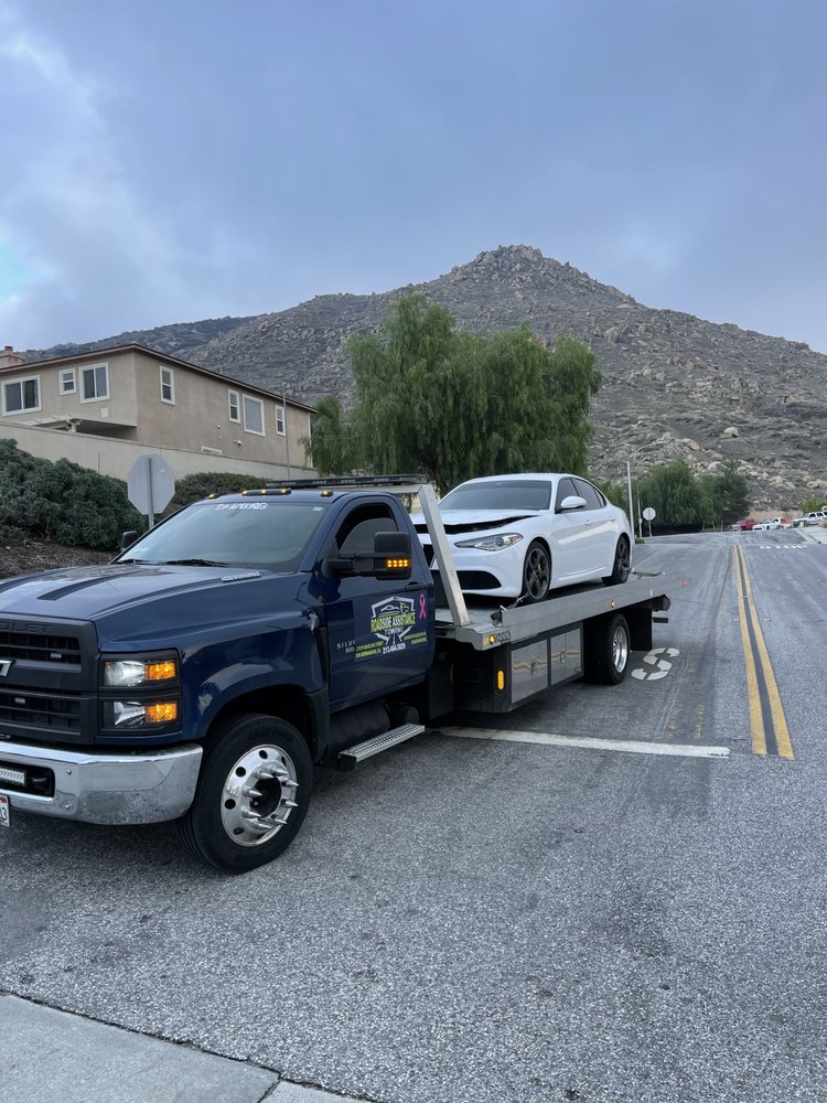 Black flatbed tow truck ready for dispatch